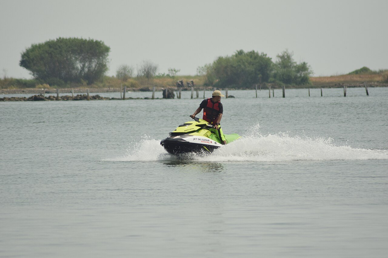 Jet ski moving across open water during warm-season sea sports