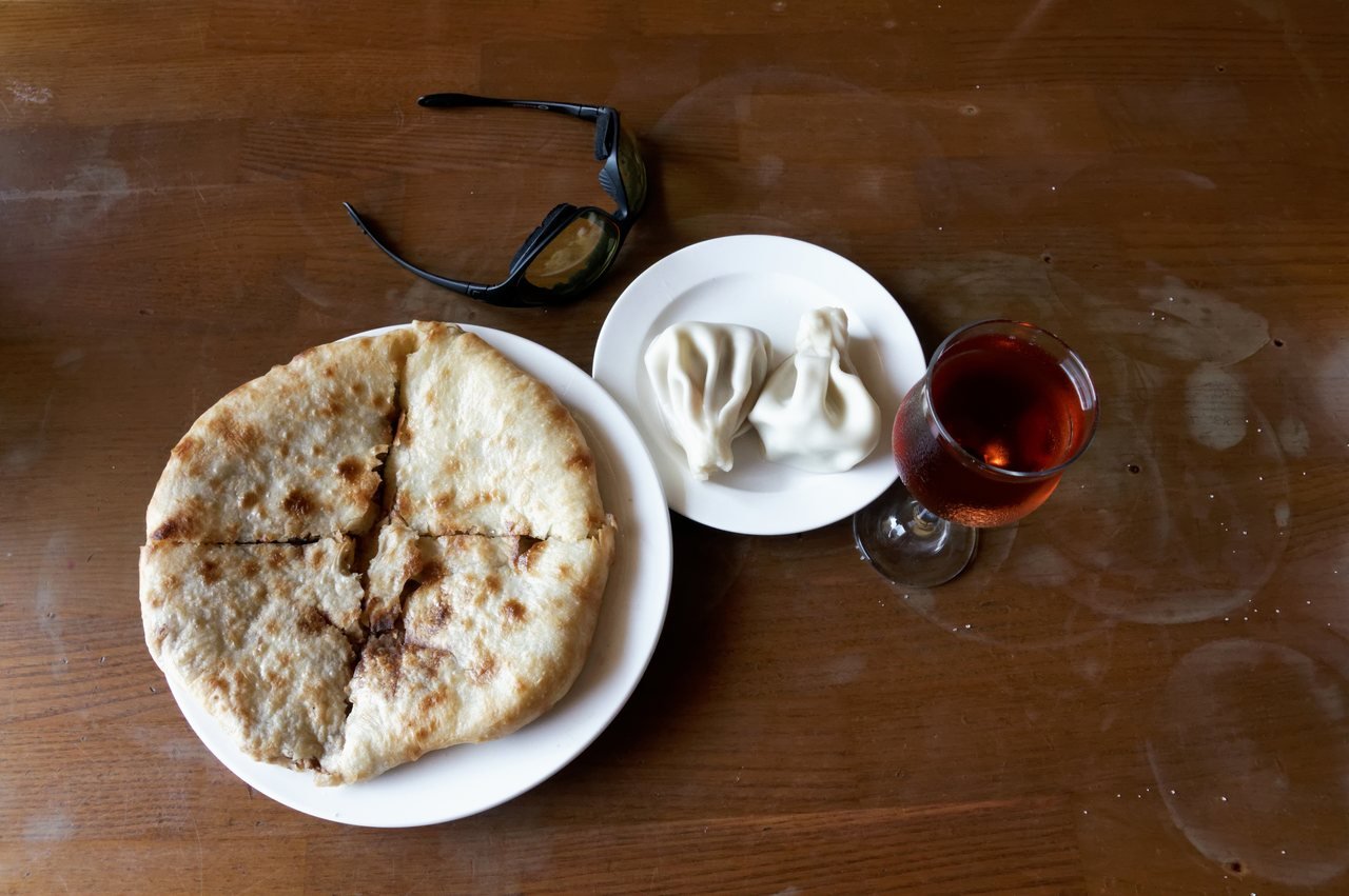 Georgian khachapuri, khinkali and shared dishes on a table