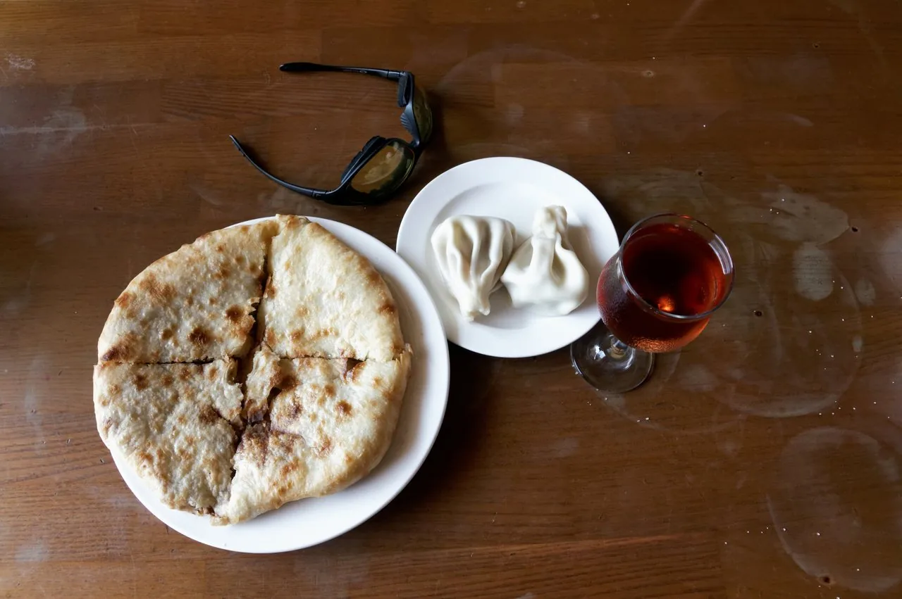 Georgian khachapuri, khinkali and shared dishes on a table